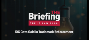 Graphic with episode title: IOC Gets Gold In Trademark Enforcement